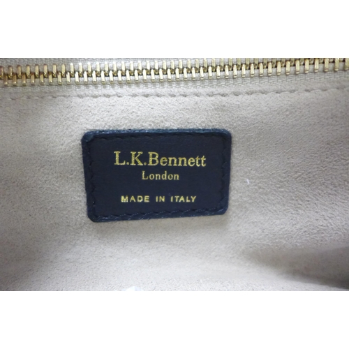 2098 - A black leather L K Bennett handbag with gold detailing and matching dust bag