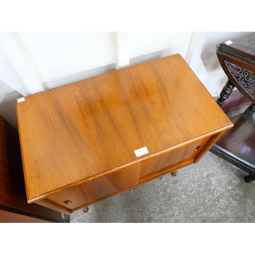 19 - A walnut sliding door record cabinet