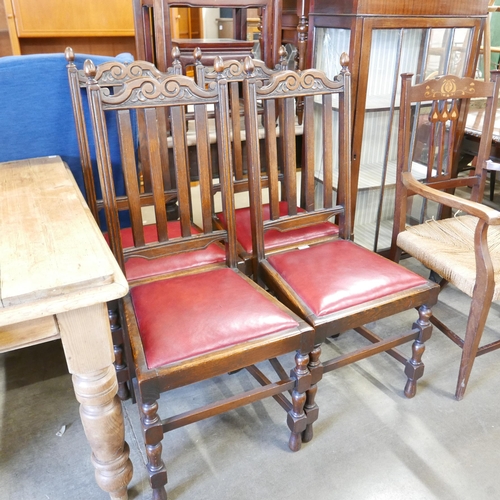 A set of four early 20th Century carved oak dining chairs