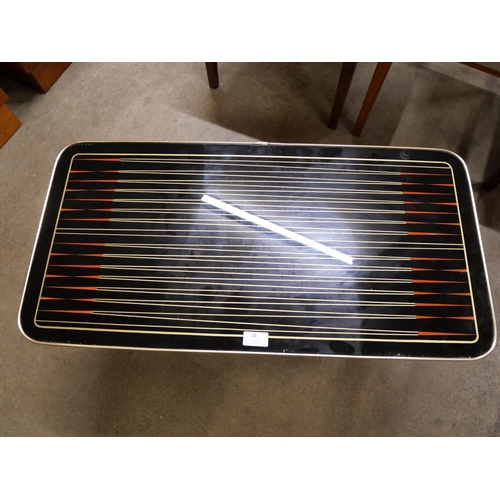 28 - A teak and black laminate Starburst pattern coffee table