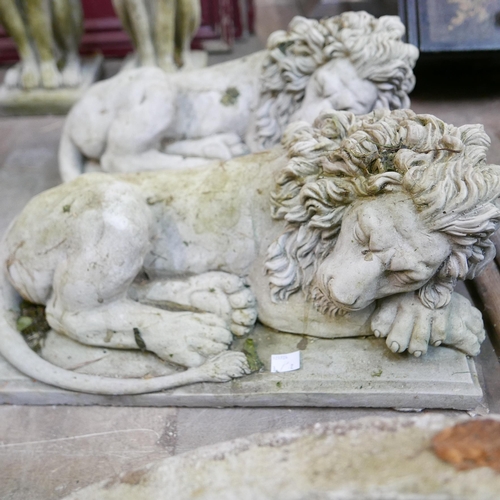 282 - A pair of concrete garden figures of recumbent lions