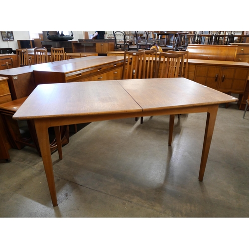 41 - A teak extending dining table