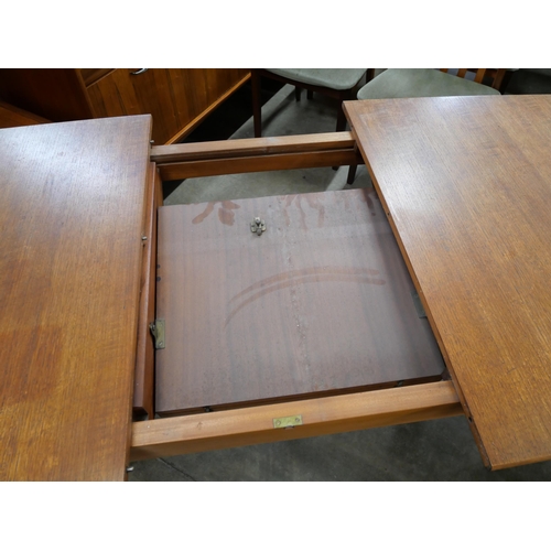 41 - A teak extending dining table