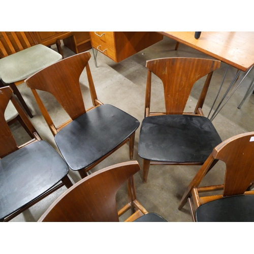 45 - A set of eight teak and black vinyl dining chairs