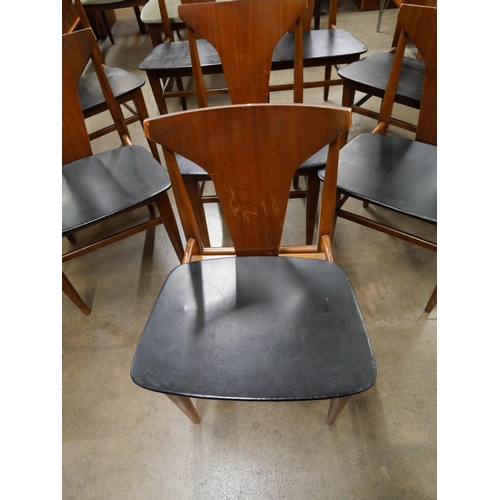 45 - A set of eight teak and black vinyl dining chairs