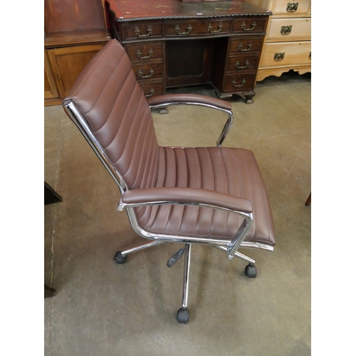 48 - An Eames style chrome and brown leather revolving desk chair