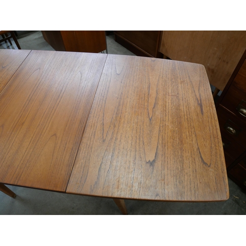 49 - A teak extending dining table