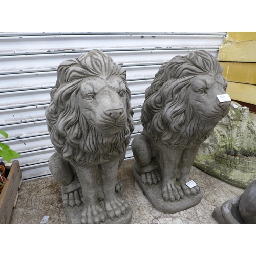 2198 - A pair of stone effect concrete lion garden ornaments - approximately 23