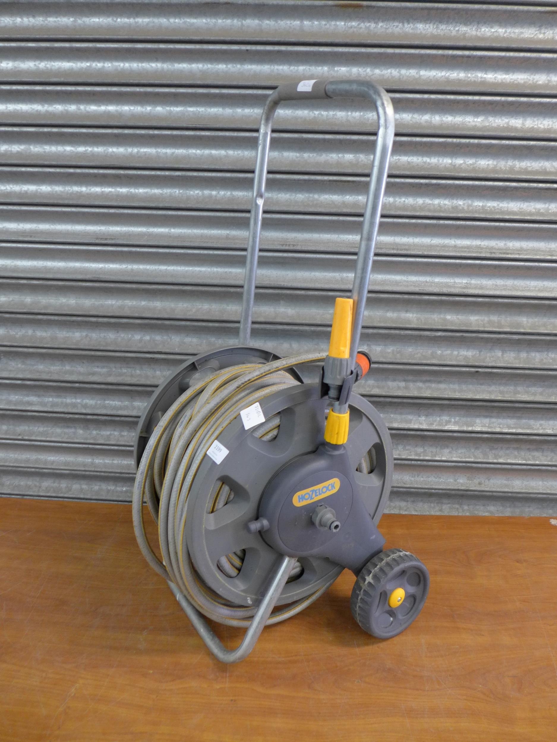 A Hozelock hose pipe and trolley reel