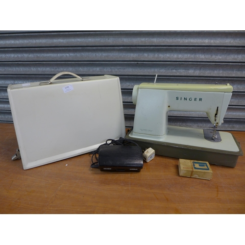 2296 - A Singer electric sewing machine with foot pedal in hard case