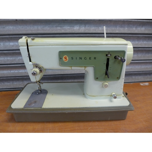 2296 - A Singer electric sewing machine with foot pedal in hard case