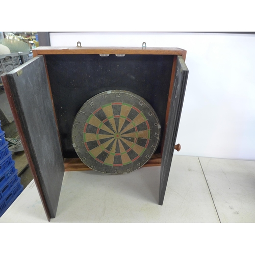 2372 - A large quantity of miscellaneous household items including a vintage dartboard and cabinet, a coal ... 