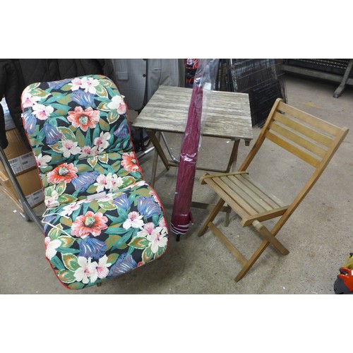 2383 - A folding wooden garden table and two chairs with parasol and seat cushions