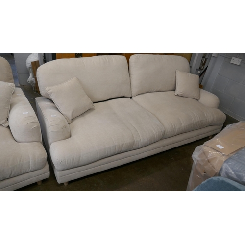 1454 - A beige velvet three seater sofa RRP £949