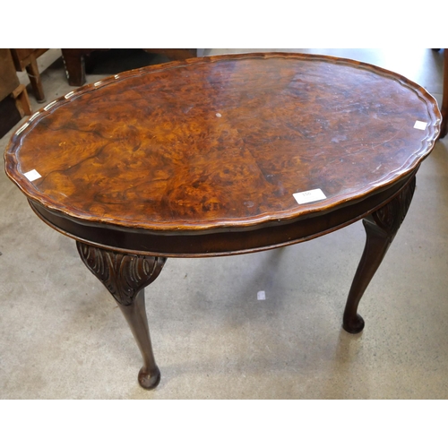 168 - A Queen Anne style burr walnut oval coffee table