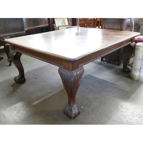 194 - An early 20th Century Queen Anne style mahogany dining table, with additional leaf and winding handl... 