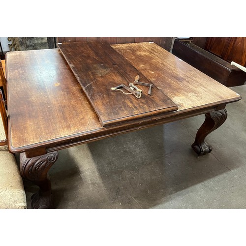 194 - An early 20th Century Queen Anne style mahogany dining table, with additional leaf and winding handl... 