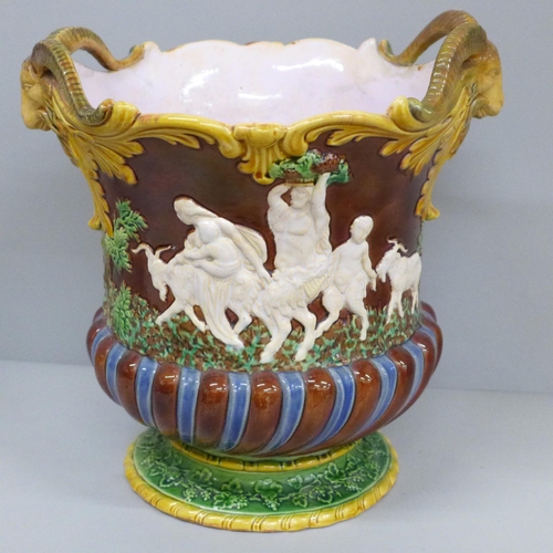 615 - A 19th Century majolica jardinière with ram's head detail and embossed with classical Roman scenes, ... 