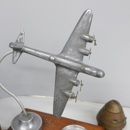 641 - An ash tray with bomber plane decoration, a lamp and an ammunition nose cone