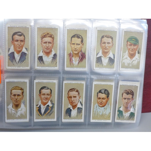 683 - Cigarette cards; an album containing ten sets of Players cigarette cards, including cricketers, 1934... 