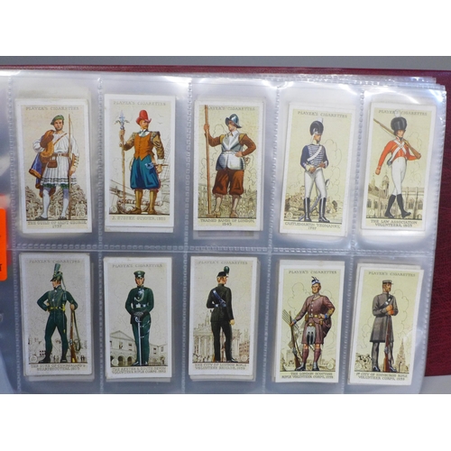 683 - Cigarette cards; an album containing ten sets of Players cigarette cards, including cricketers, 1934... 