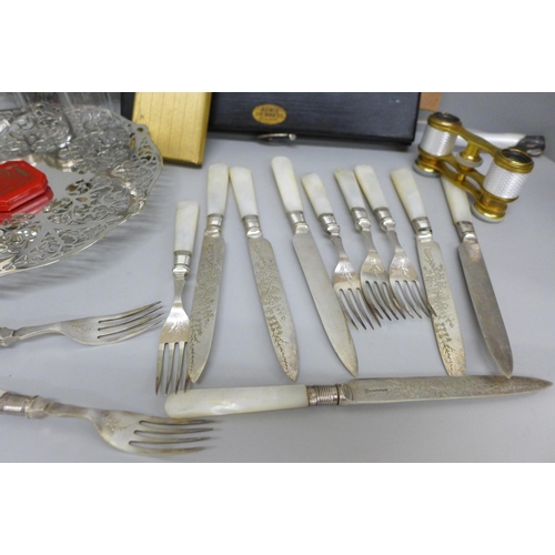 703 - A pierced dish, dessert knives and forks, glass jars, a pair of French opera glasses, guilloche enam... 