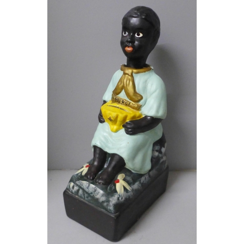 787 - A French charity money box in the form of a seated child with rocking head