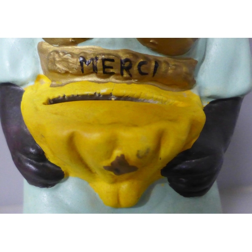 787 - A French charity money box in the form of a seated child with rocking head