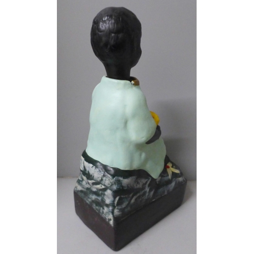 787 - A French charity money box in the form of a seated child with rocking head