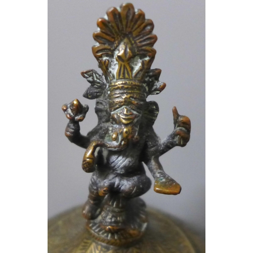 802 - A chase engraved brass Indian lidded caddy with Ganesha top detail, 33cm and a leather powder case w... 