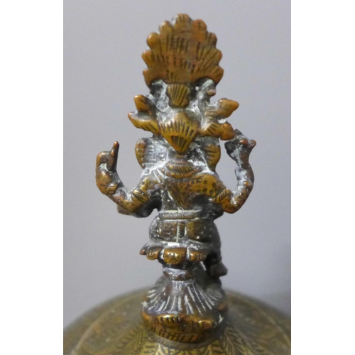 802 - A chase engraved brass Indian lidded caddy with Ganesha top detail, 33cm and a leather powder case w... 