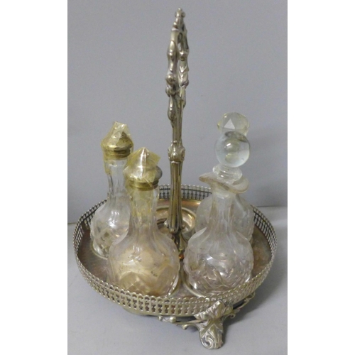 812 - Two plated cruet sets, one six bottle with missing glass bottle and an ornate six bottle cruet set w... 