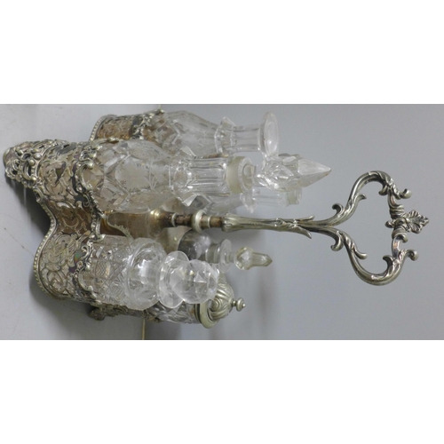 812 - Two plated cruet sets, one six bottle with missing glass bottle and an ornate six bottle cruet set w... 