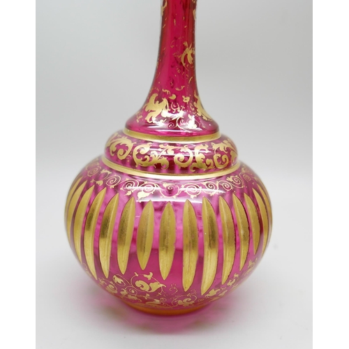 836 - A pair of early 20th Century cranberry glass bottle with lids and gilt detail and a ruby glass scent... 