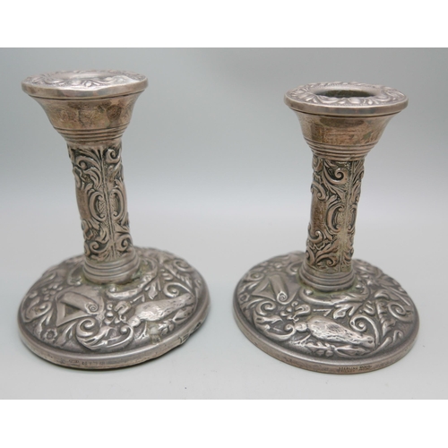 841 - A pair of silver embossed candlesticks, W. I. Broadway & Co., Birmingham 1953/54, 10cm