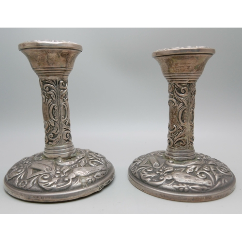 841 - A pair of silver embossed candlesticks, W. I. Broadway & Co., Birmingham 1953/54, 10cm