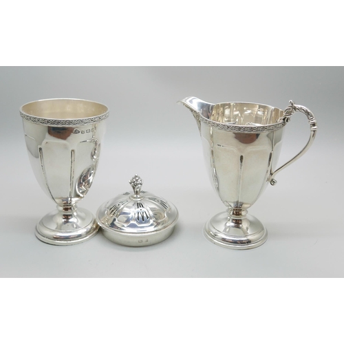 850 - A silver cream jug and a matching sugar shaker by Adie Bros., Birmingham 1935, 207g, (both bases a/f... 