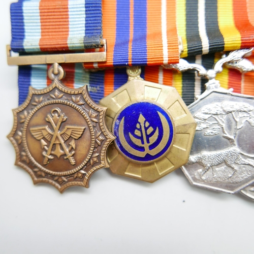 864 - A set of six mounted Rhodesian medals including South African Merit medal, a Pro Patra medal, a Sout... 