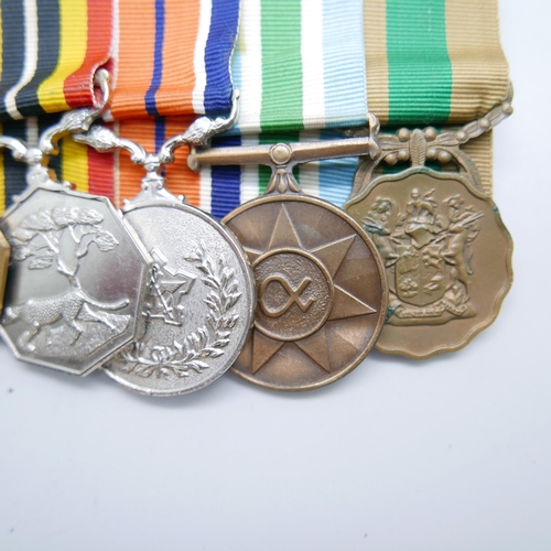 864 - A set of six mounted Rhodesian medals including South African Merit medal, a Pro Patra medal, a Sout... 