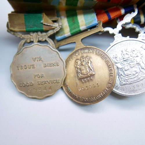 864 - A set of six mounted Rhodesian medals including South African Merit medal, a Pro Patra medal, a Sout... 