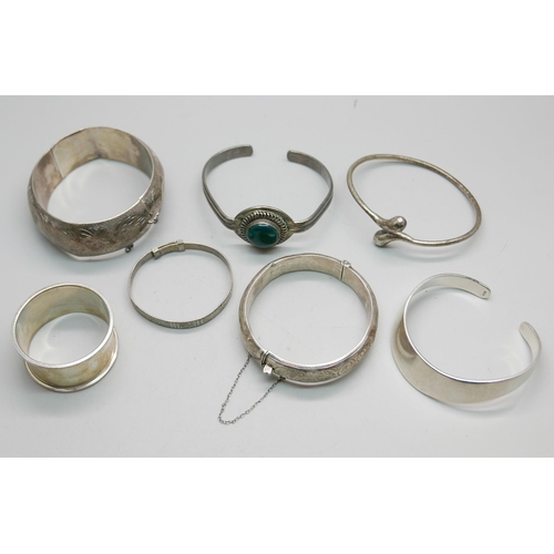 874 - Six silver bangles and a silver napkin ring, 158g