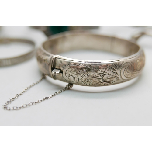 874 - Six silver bangles and a silver napkin ring, 158g