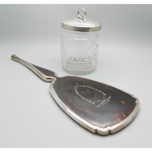 876 - A silver and tortoiseshell hand mirror and a silver topped glass preserve jar, lid 37g