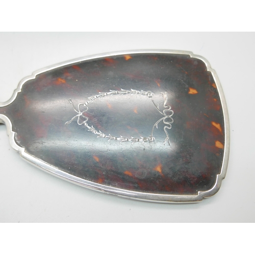 876 - A silver and tortoiseshell hand mirror and a silver topped glass preserve jar, lid 37g