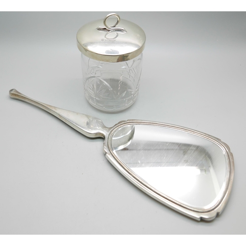 876 - A silver and tortoiseshell hand mirror and a silver topped glass preserve jar, lid 37g