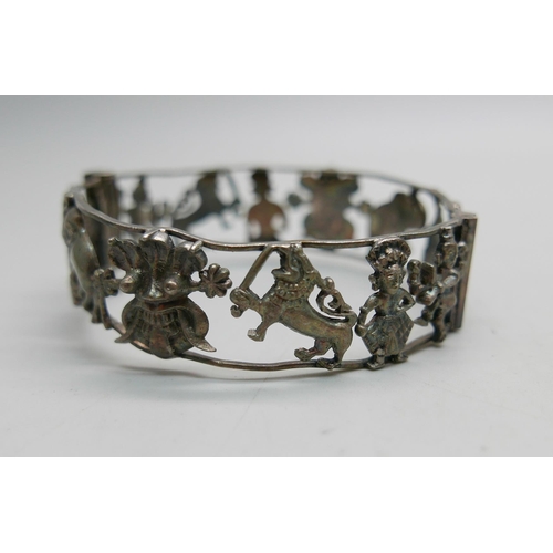 907 - One vintage eastern inspired silver bangle with temples, elephants, etc., and a silver cable hinged ... 