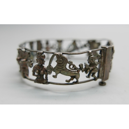 907 - One vintage eastern inspired silver bangle with temples, elephants, etc., and a silver cable hinged ... 