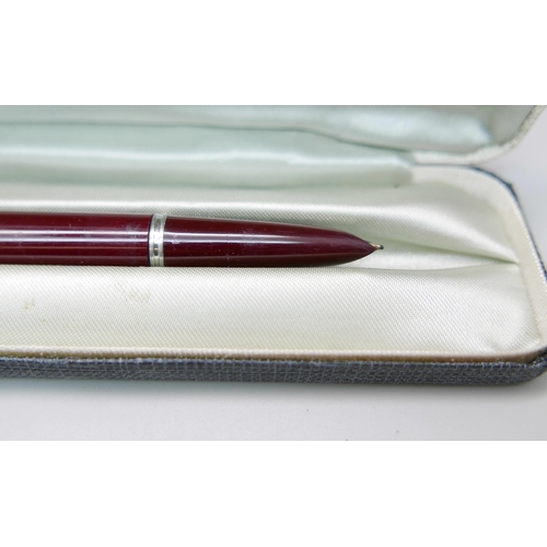 913 - A cased Sheaffer pen with 14k gold nib, a cased Parker pen with gold plated top, a cased Cross ballp... 