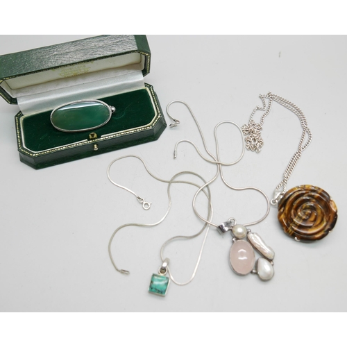 929 - Three silver and gem set pendants and chains and a gem set brooch