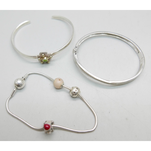 931 - Two silver bangles and a Pandora bracelet